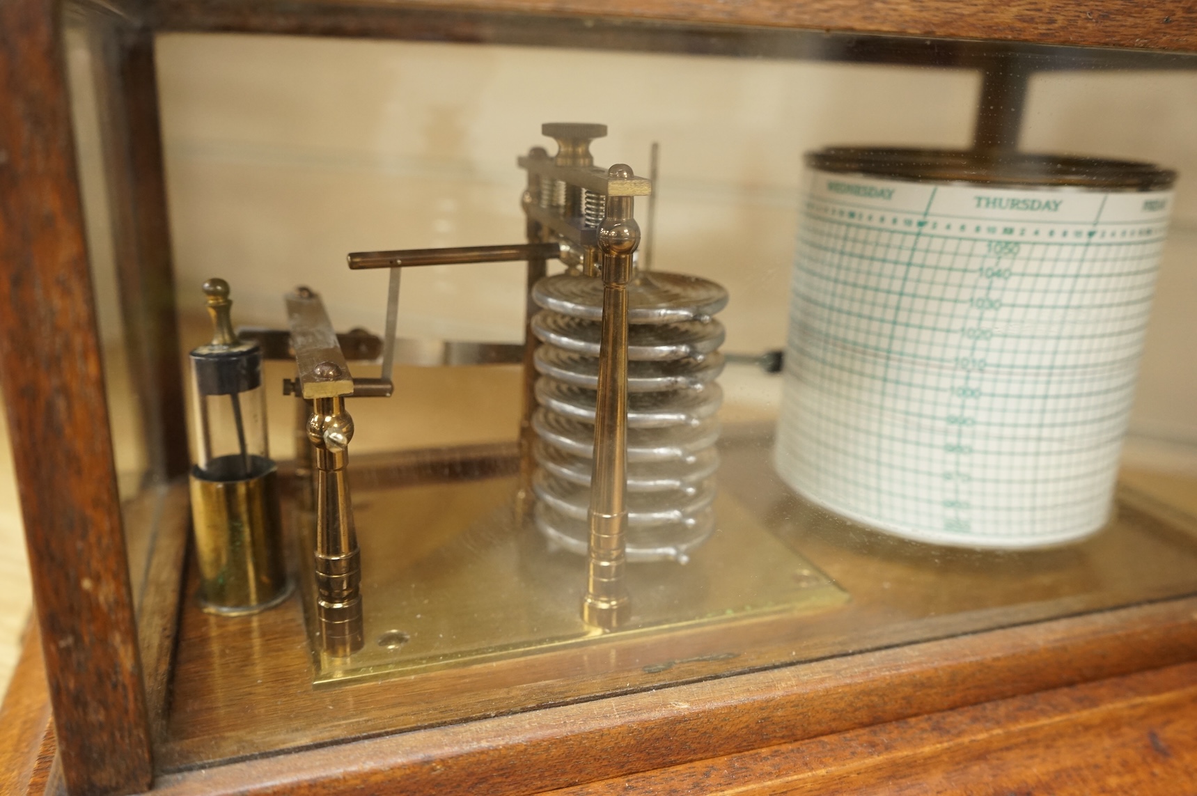 An early 20th century mahogany cased barograph by an unknown maker, with a quantity of unused papers.